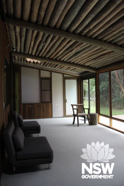 Detail of interior of Myer House showing enclosed verandah with hand-crafted wooden chair