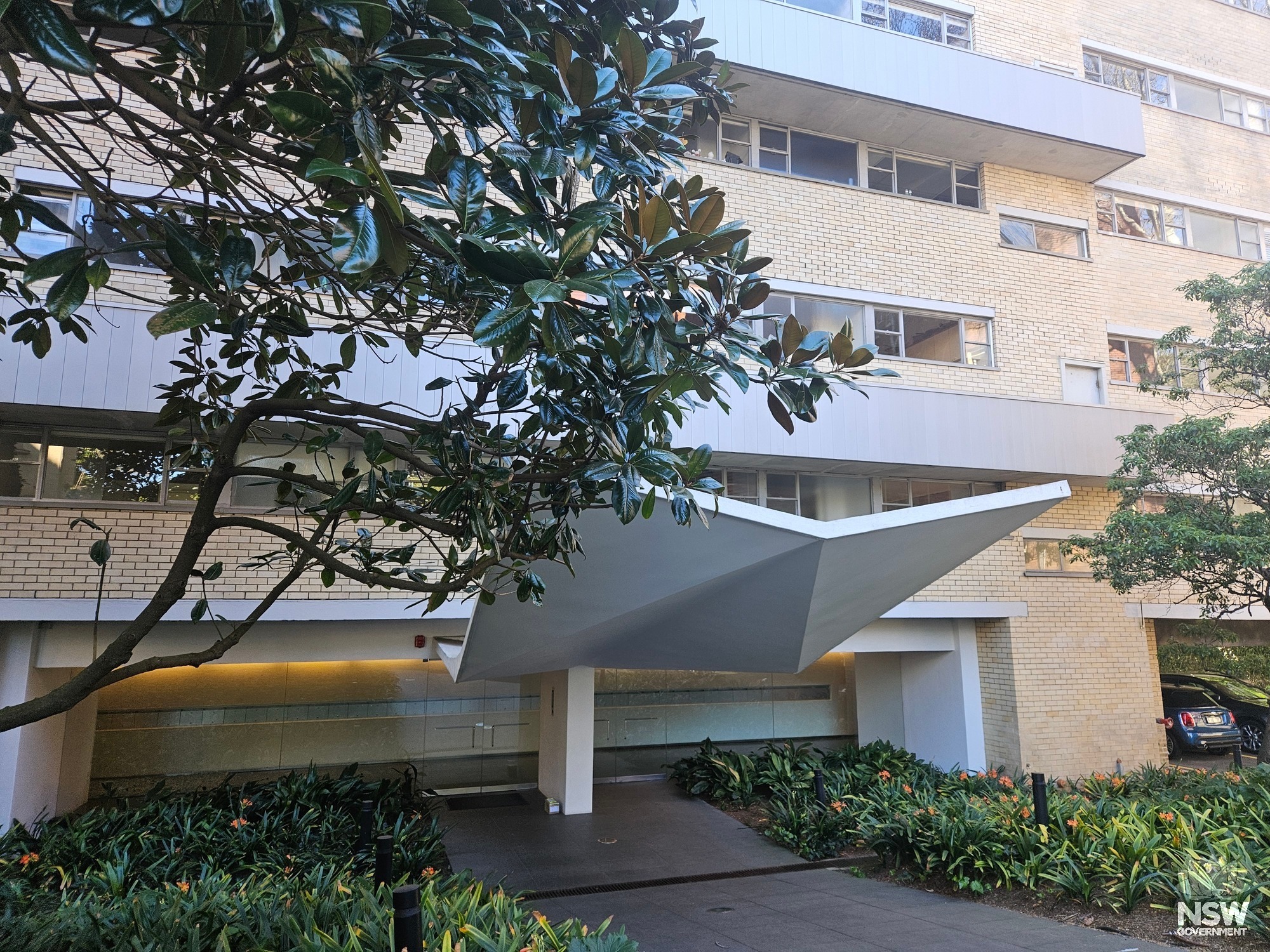 Ithaca Gardens. Main entrance with folded concrete canopy.